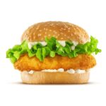 High resolution, digital capture of a fried chicken sandwich with lettuce and mayonnaise on a fresh sesame seed bun, set against a clean, white background sweep. Shot in an aspirational advertising style.